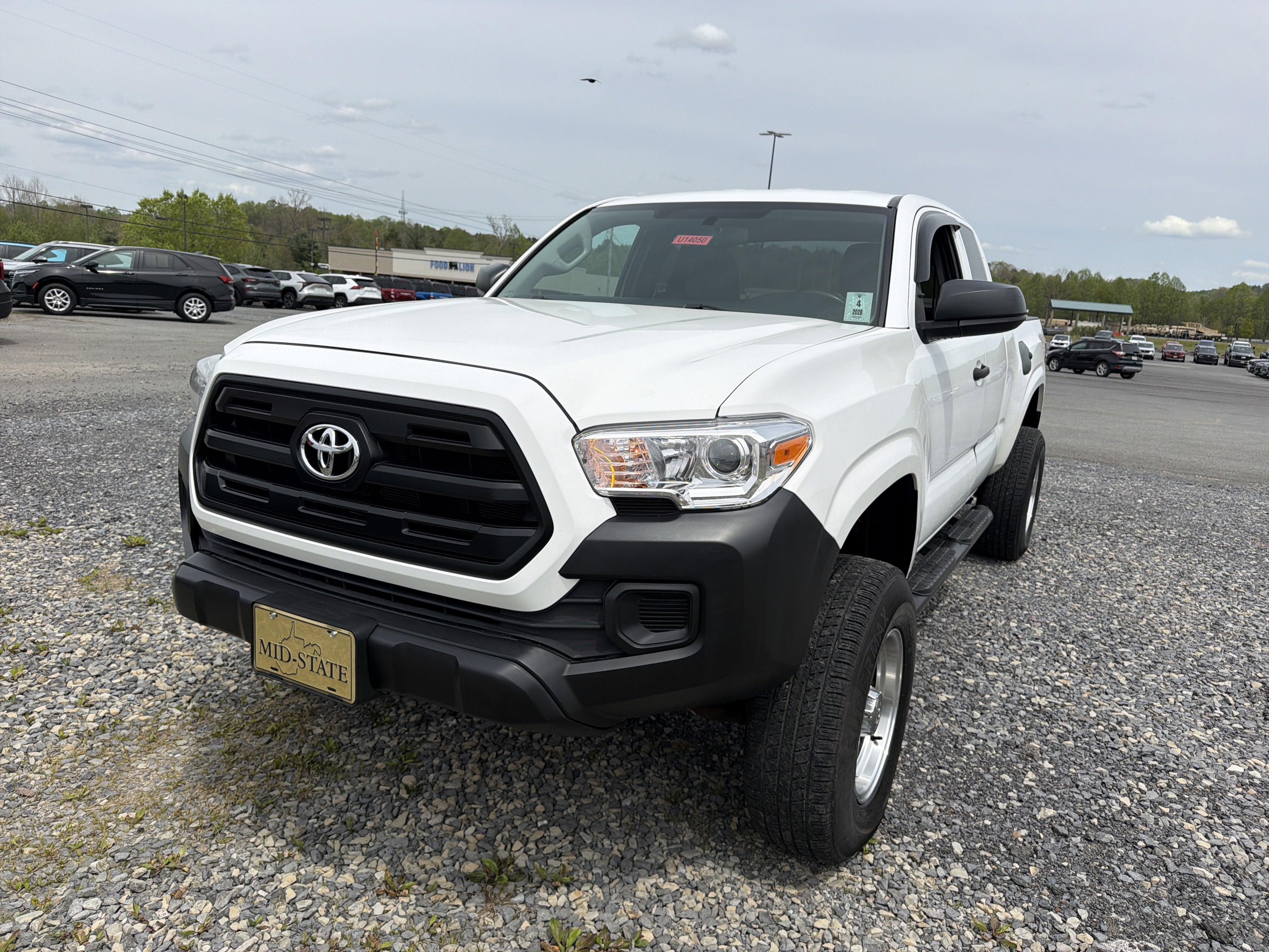 2016 Toyota Tacoma SR in Super White — front three-quarter view